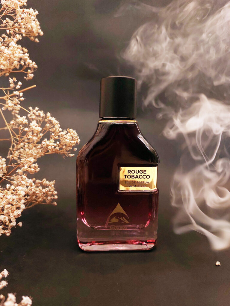 Rouge tobacco is an outstanding and well balanced fragrance for men and women. Initially the black rose and tobacco are the main stars but later it settles to a very fruity and romantic smell because of the Plum and vanilla. The perfect balance of cinammon enchances the smell of tobacco even more. Overall its one of the most unique and best fragrance available by Aura de arabia